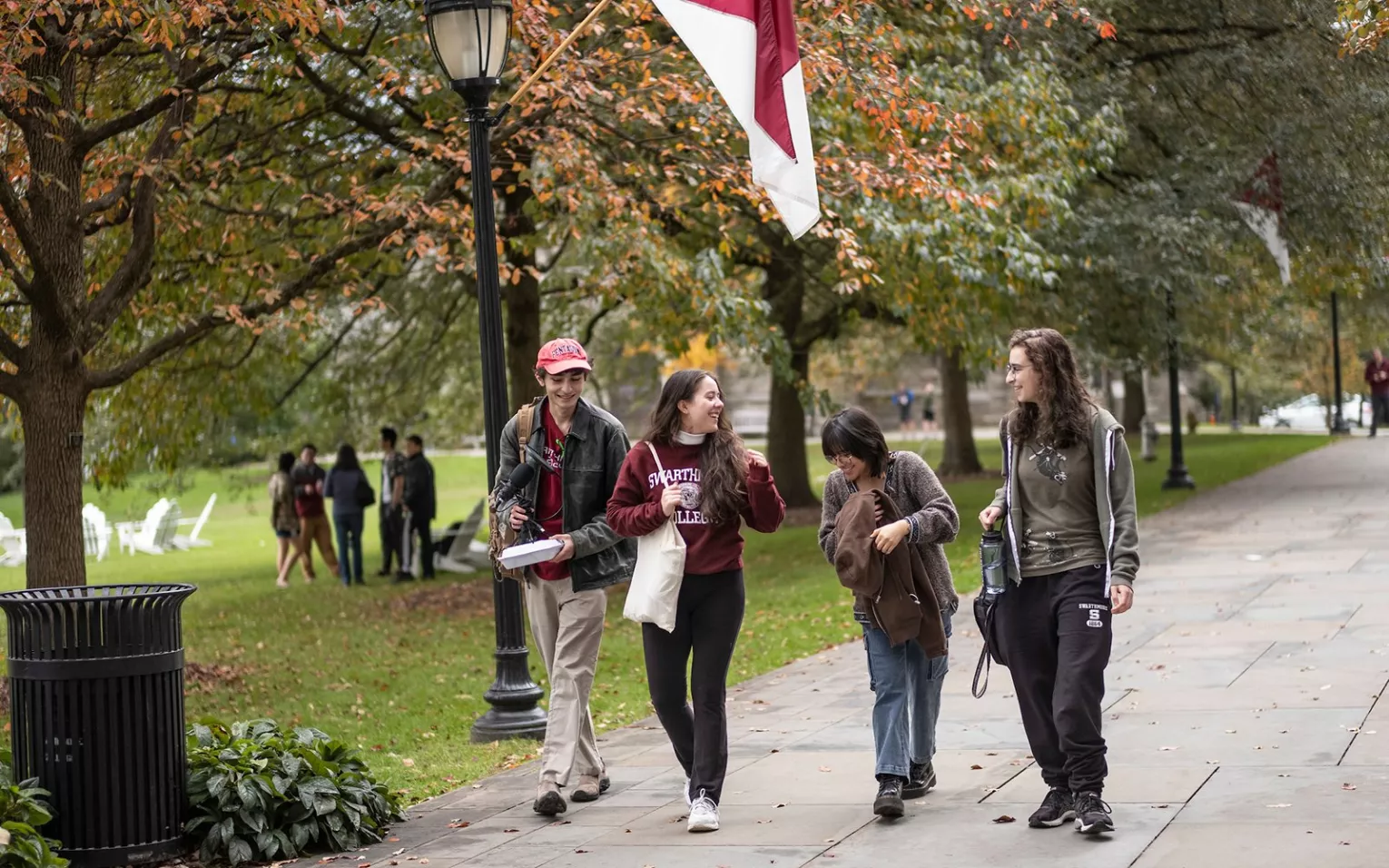 Four young people walk along Magill Walk